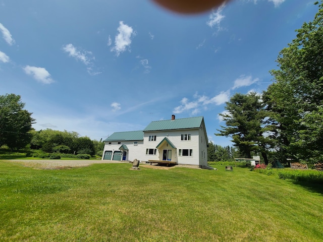 163 Ayer Ridge Rd, Freedom, ME 04941 - back of property with a chimney, driveway, a yard, and a metal roof