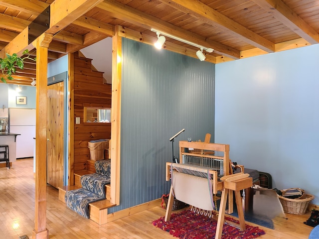 163 Ayer Ridge Rd, Freedom, ME 04941 - home office with a wood ceiling with exposed beams, hardwood / wood-style flooring, wood walls, and rail lighting