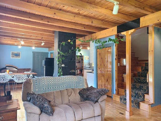 163 Ayer Ridge Rd, Freedom, ME 04941 - living room with a wood ceiling with exposed beams, light wood finished floors, and stairway