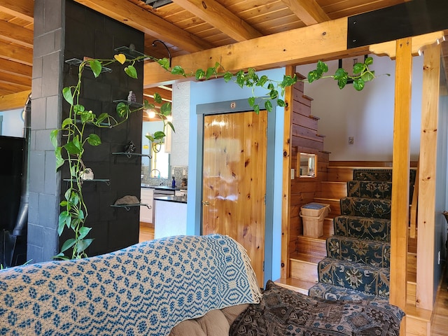 163 Ayer Ridge Rd, Freedom, ME 04941 - bedroom featuring a wood ceiling with exposed beams, wooden walls, and light wood-style flooring