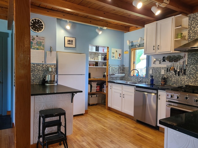 163 Ayer Ridge Rd, Freedom, ME 04941 - kitchen with appliances with stainless steel finishes, open shelves, a wood ceiling with exposed beams, dark countertops, and decorative backsplash