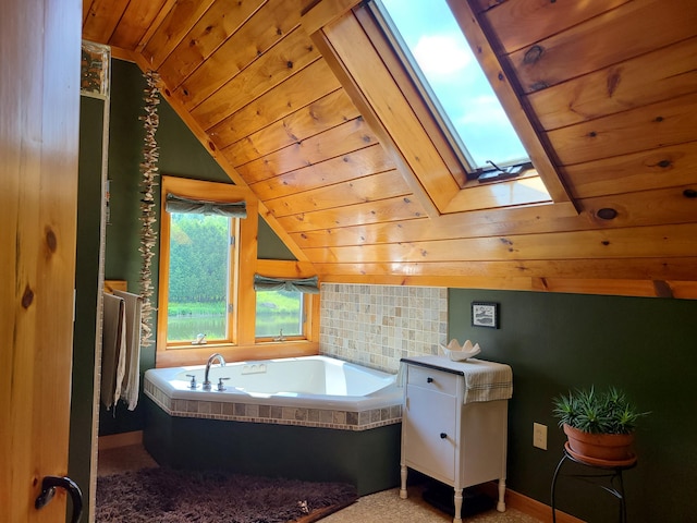 163 Ayer Ridge Rd, Freedom, ME 04941 - bathroom featuring wood ceiling, lofted ceiling, a garden tub, and a skylight