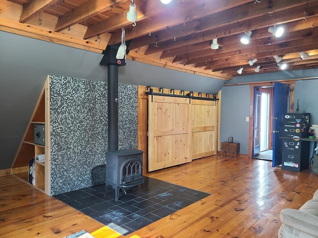 163 Ayer Ridge Rd, Freedom, ME 04941 - unfurnished living room with hardwood / wood-style floors, a wood stove, and rail lighting