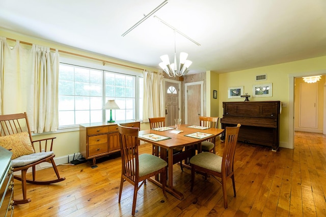 184 Mountain St, Camden, ME 04843 - dining area with a chandelier, light wood-style floors, and track lighting