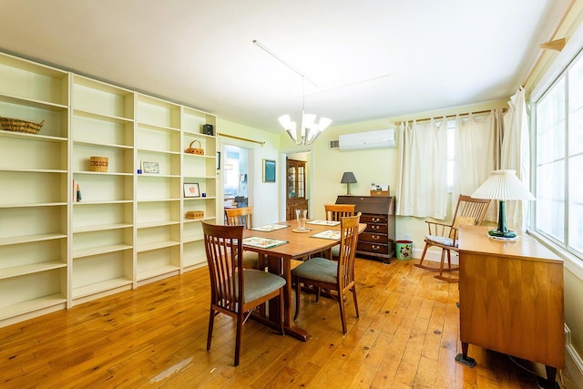 184 Mountain St, Camden, ME 04843 - dining room featuring a chandelier, hardwood / wood-style floors, and an AC wall unit