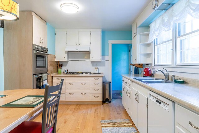 184 Mountain St, Camden, ME 04843 - kitchen with dishwasher, stainless steel double oven, light wood-style floors, and light countertops