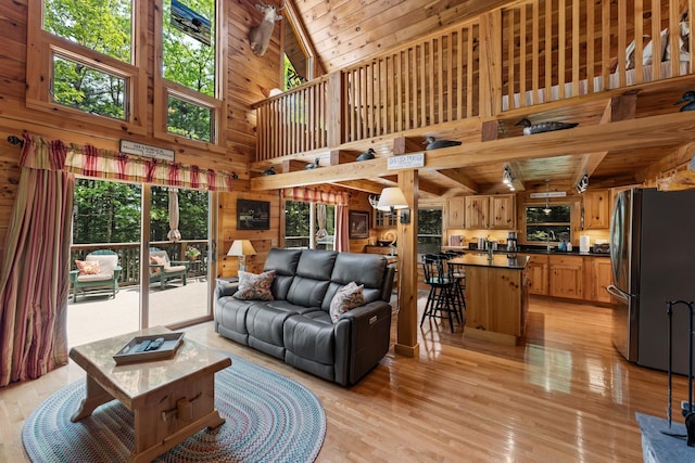 50 Flagg Way, Fayette, ME 04349 - living room with a high ceiling, light wood-type flooring, wooden walls, and a wood ceiling with exposed beams