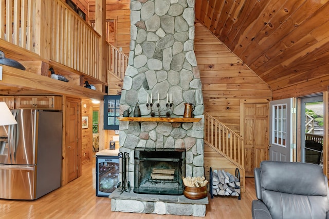 50 Flagg Way, Fayette, ME 04349 - living room featuring stairs, lofted ceiling, wooden walls, wood finished floors, and wine cooler