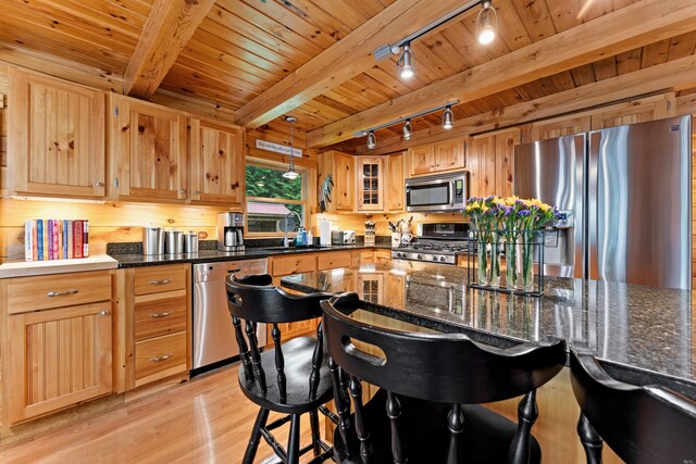 50 Flagg Way, Fayette, ME 04349 - kitchen with appliances with stainless steel finishes, rail lighting, light wood-type flooring, a breakfast bar, and a wood ceiling with exposed beams