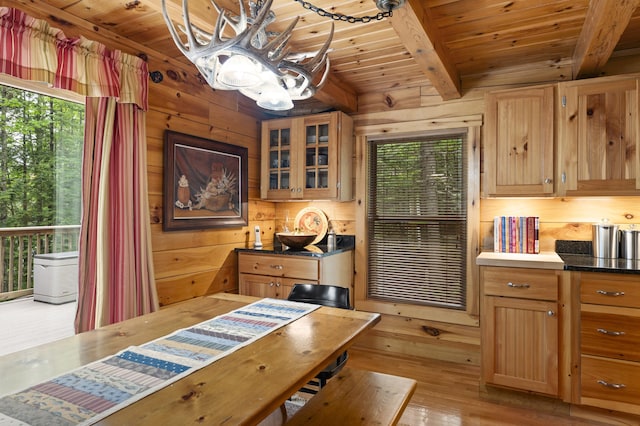 50 Flagg Way, Fayette, ME 04349 - dining area with a wooden ceiling with exposed beams, a chandelier, wooden walls, and light wood-style flooring