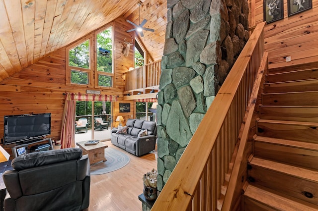 50 Flagg Way, Fayette, ME 04349 - living area with wooden walls, high vaulted ceiling, wood ceiling, stairs, and wood finished floors