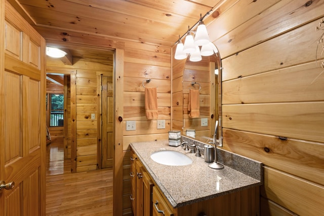 50 Flagg Way, Fayette, ME 04349 - bathroom with vanity, wood finished floors, and wood walls