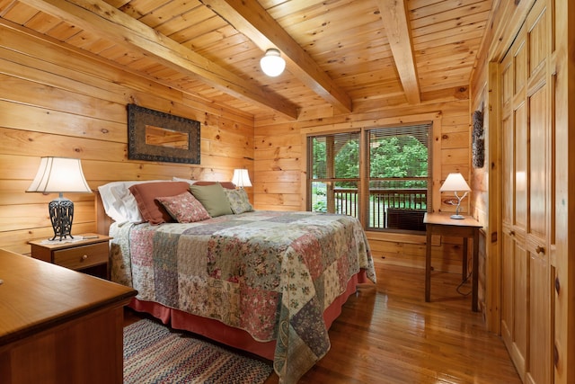 50 Flagg Way, Fayette, ME 04349 - bedroom featuring wood finished floors, wood walls, a wooden ceiling with exposed beams, and access to exterior