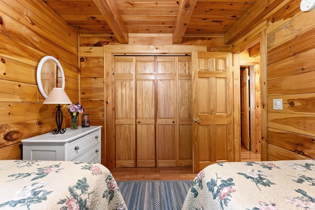 50 Flagg Way, Fayette, ME 04349 - bedroom featuring a wood ceiling with exposed beams, wooden walls, and light wood-style floors