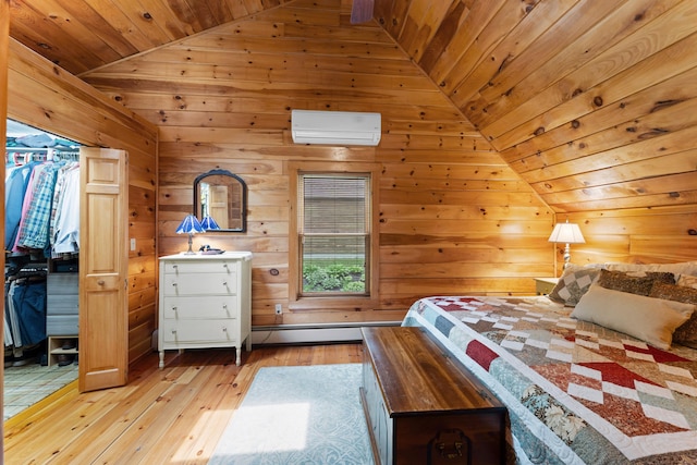 50 Flagg Way, Fayette, ME 04349 - bedroom featuring an AC wall unit, lofted ceiling, light wood finished floors, a baseboard heating unit, and wooden walls