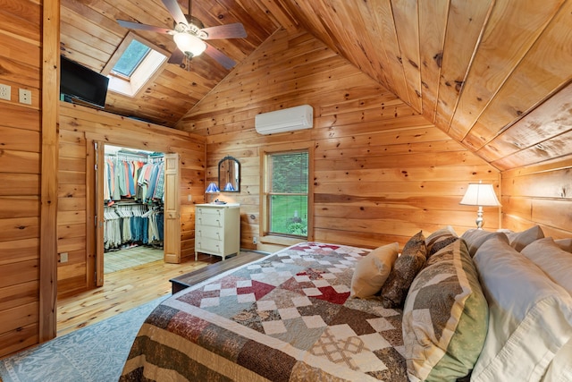 50 Flagg Way, Fayette, ME 04349 - bedroom featuring a wall unit AC, lofted ceiling, wooden ceiling, wooden walls, and light wood-style floors