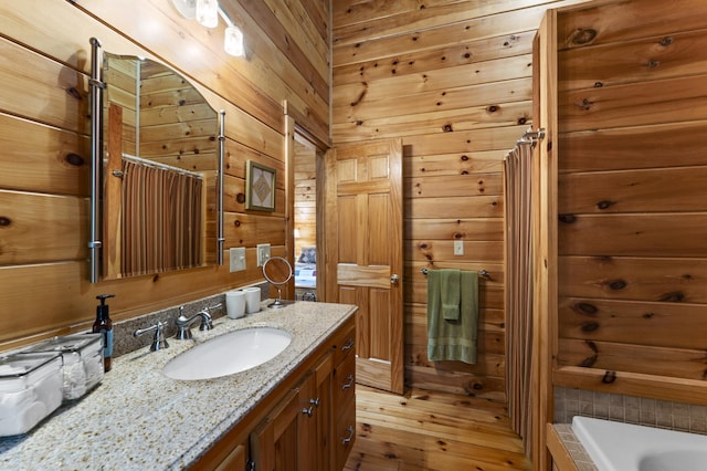 50 Flagg Way, Fayette, ME 04349 - full bath featuring vanity, a tub, wood walls, and wood-type flooring
