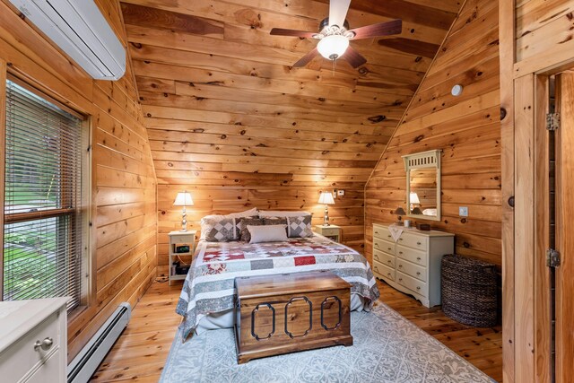 50 Flagg Way, Fayette, ME 04349 - bedroom featuring a baseboard heating unit, a wall unit AC, light wood finished floors, vaulted ceiling, and wood walls