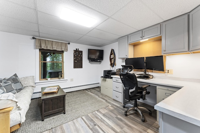 50 Flagg Way, Fayette, ME 04349 - office featuring baseboard heating, a drop ceiling, light wood-type flooring, and built in desk