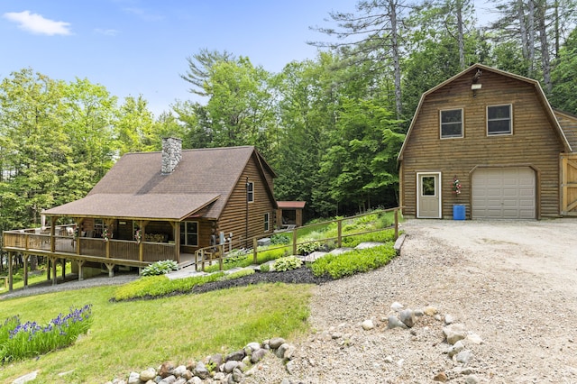 50 Flagg Way, Fayette, ME 04349 - view of front of home featuring an attached garage, a chimney, dirt driveway, a gambrel roof, and a shingled roof