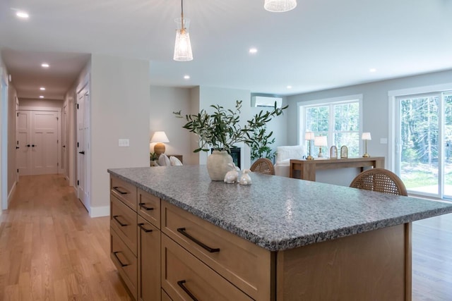 59 Sagamore Dr Lot 28, Phippsburg, ME 04562 - kitchen with light wood finished floors, a center island, recessed lighting, light stone counters, and hanging light fixtures