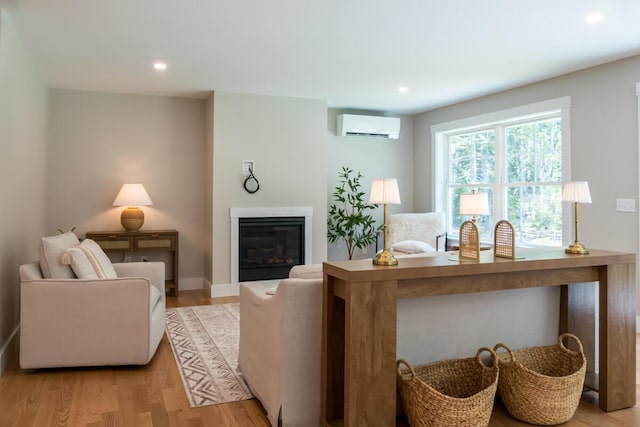 59 Sagamore Dr Lot 28, Phippsburg, ME 04562 - living area featuring a wall mounted AC, light wood finished floors, a glass covered fireplace, and recessed lighting