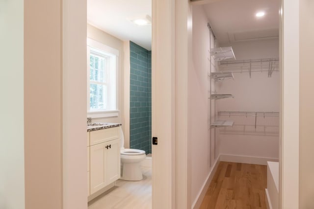 59 Sagamore Dr Lot 28, Phippsburg, ME 04562 - bathroom featuring vanity, wood finished floors, a spacious closet, and a shower