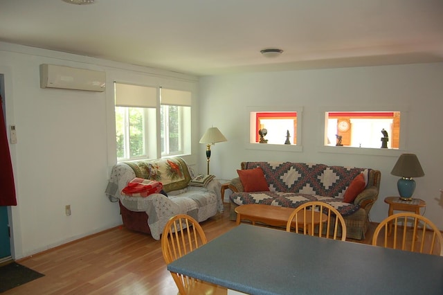 803 Main Rd, Burlington, ME 04417 - living room featuring an AC wall unit and light wood finished floors