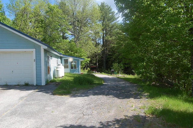 803 Main Rd, Burlington, ME 04417 - view of side of home featuring a garage