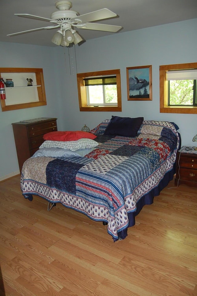 803 Main Rd, Burlington, ME 04417 - bedroom with wood finished floors, multiple windows, and ceiling fan