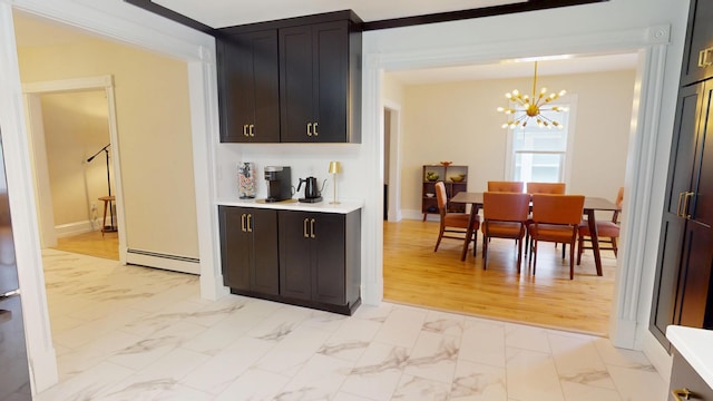 295 French St, Bangor, ME 04401 - kitchen with light marble finish flooring, a chandelier, light countertops, baseboard heating, and hanging light fixtures