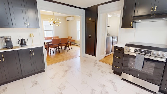 295 French St, Bangor, ME 04401 - kitchen featuring stainless steel range with electric cooktop, under cabinet range hood, a chandelier, a wall mounted air conditioner, and light marble finish floors