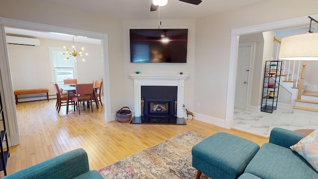 295 French St, Bangor, ME 04401 - living area with a wall unit AC, a ceiling fan, baseboard heating, a chandelier, and stairs