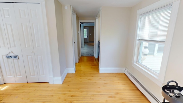 295 French St, Bangor, ME 04401 - hall with light wood finished floors and a baseboard heating unit