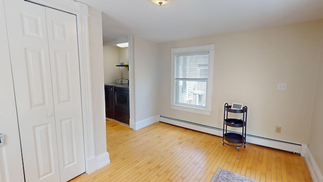 295 French St, Bangor, ME 04401 - exercise room featuring hardwood / wood-style flooring, washer and dryer, and a baseboard heating unit