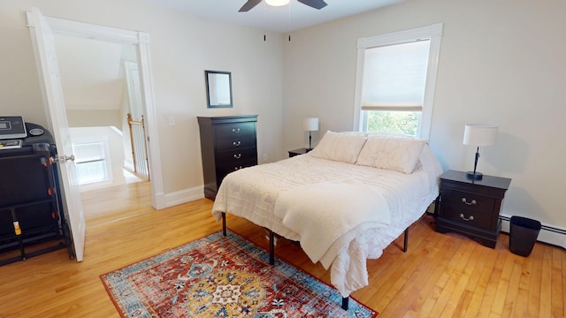 295 French St, Bangor, ME 04401 - bedroom with wood finished floors, a ceiling fan, and a baseboard radiator