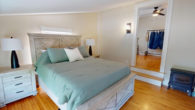 295 French St, Bangor, ME 04401 - bedroom featuring light wood finished floors and a wood stove