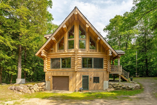 320 Commons Dr, Bridgton, ME 04009 - view of front of property with log exterior, driveway, an attached garage, and stairs