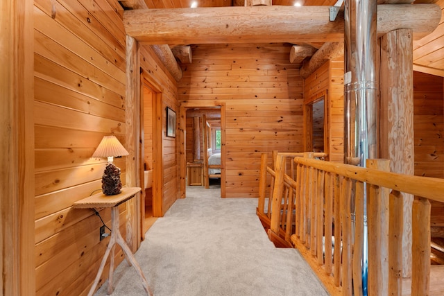 320 Commons Dr, Bridgton, ME 04009 - corridor with wooden walls, beam ceiling, carpet floors, and an upstairs landing