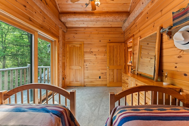 320 Commons Dr, Bridgton, ME 04009 - carpeted bedroom featuring wooden walls and a wooden ceiling with exposed beams