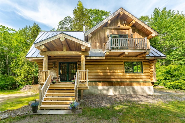 320 Commons Dr, Bridgton, ME 04009 - log cabin featuring a standing seam roof, log siding, a porch, and a metal roof