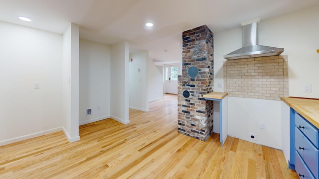 14 Pond St, Orono, ME 04473 - kitchen with wall chimney range hood, wood counters, light wood-type flooring, recessed lighting, and blue cabinetry