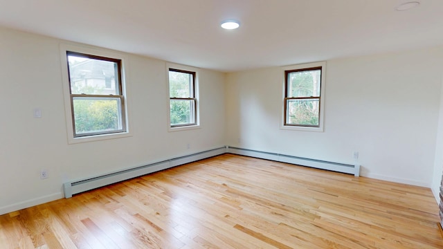 14 Pond St, Orono, ME 04473 - empty room with a baseboard radiator and light wood-style flooring