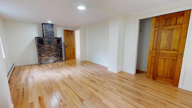 14 Pond St, Orono, ME 04473 - unfurnished living room featuring a baseboard heating unit, light wood-type flooring, and recessed lighting