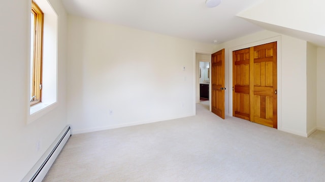 14 Pond St, Orono, ME 04473 - unfurnished bedroom with baseboard heating, light carpet, and a closet