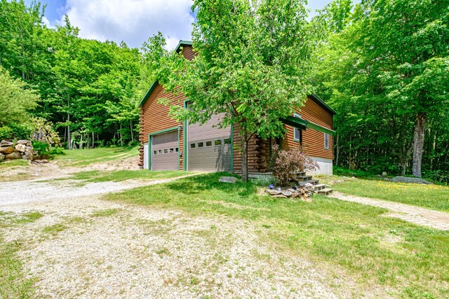 309A Cushman Rd, Woodstock, ME 04219 - view of property exterior featuring a garage and log siding