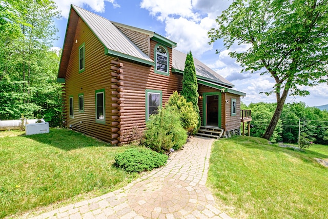 309A Cushman Rd, Woodstock, ME 04219 - log home with log siding, a front yard, and a metal roof
