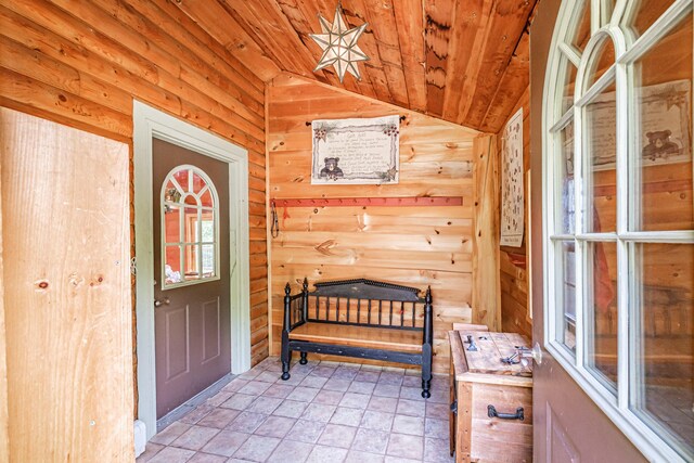 309A Cushman Rd, Woodstock, ME 04219 - foyer entrance featuring wooden ceiling, lofted ceiling, wood walls, and light stone finish floors
