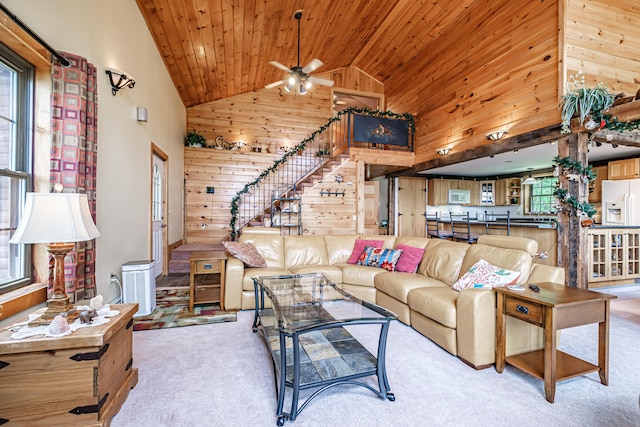 309A Cushman Rd, Woodstock, ME 04219 - living area featuring high vaulted ceiling, wood ceiling, wood walls, light carpet, and stairway