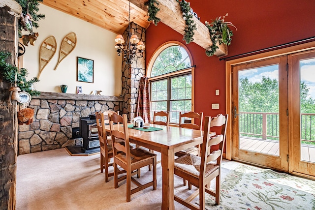 309A Cushman Rd, Woodstock, ME 04219 - carpeted dining room with a wood stove, wood ceiling, and high vaulted ceiling